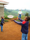 Visitor playing frisbee with the boys
