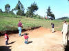 Visitor playing ball with boys